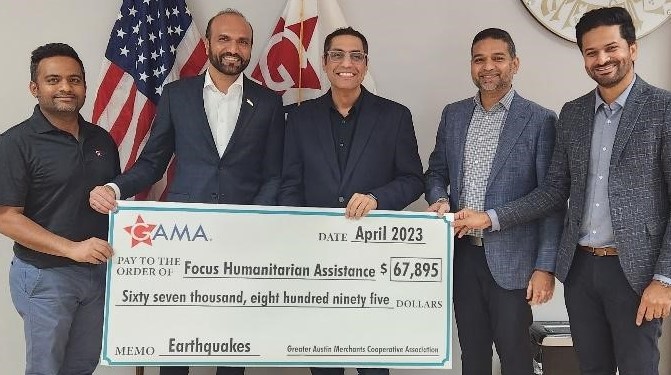 Group of men holding a big cheque